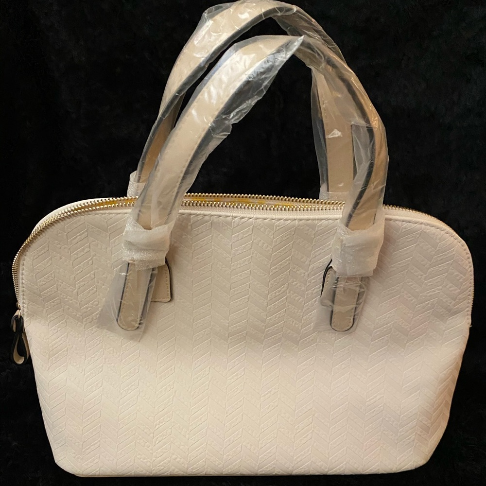 White handbag with cosmetic bag and scarf